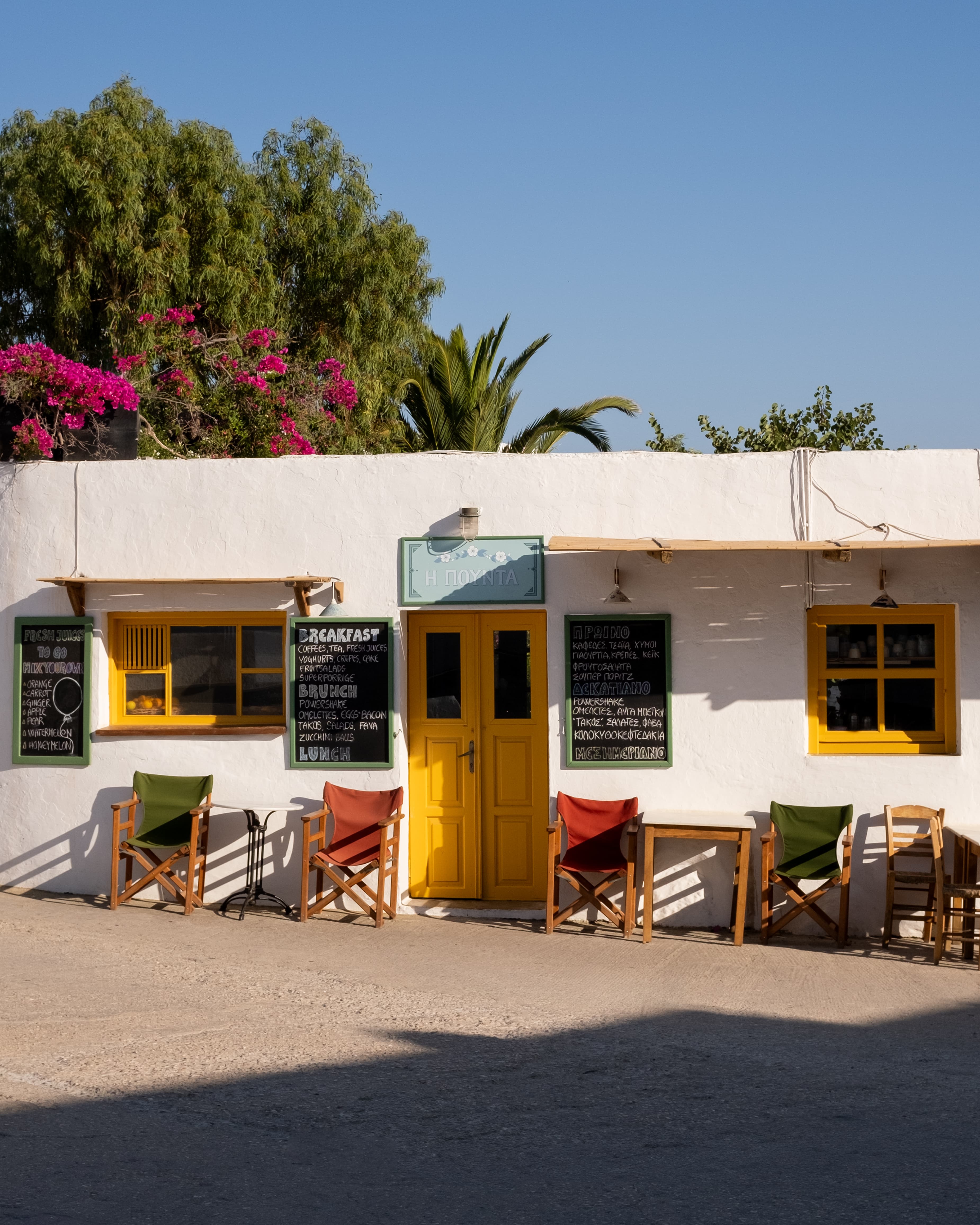 Charming Greek Taverna with Vibrant Yellow Details on a Sunny Folegandros Island Day